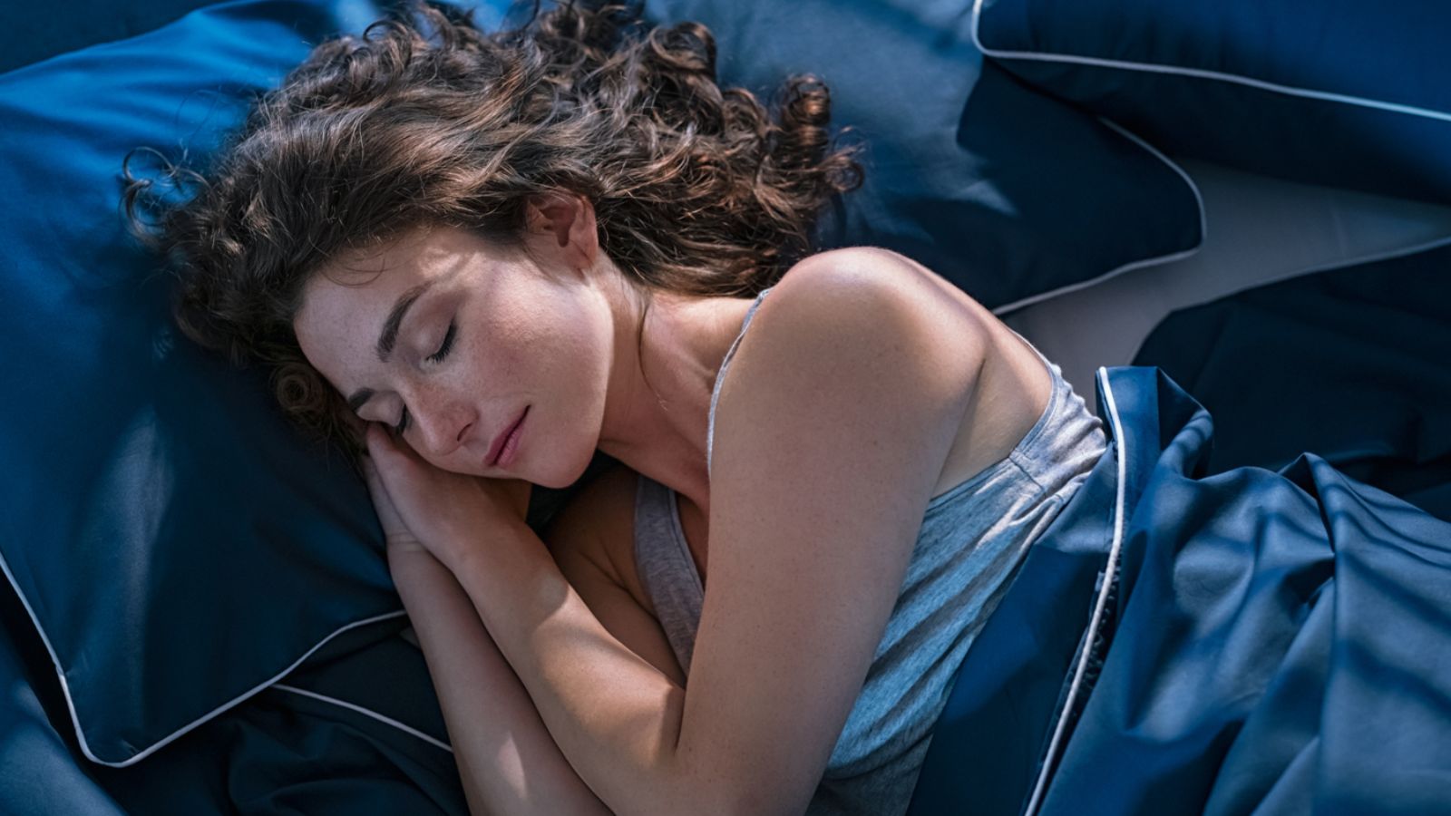 This image has an empty alt attribute; its file name is woman-sleeping-Ground-Picture-Shutterstock.jpg